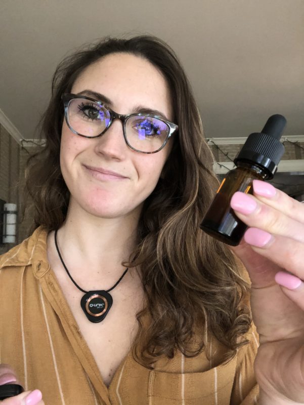 girl holding tincture bottle